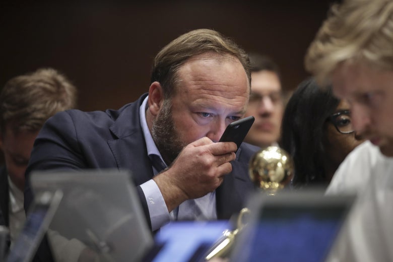 Alex Jones of InfoWars speaks into his phone during a Senate Intelligence Committee hearing concerning foreign influence operations' use of social media platforms, on Capitol Hill, September 5, 2018 in Washington, D.C.